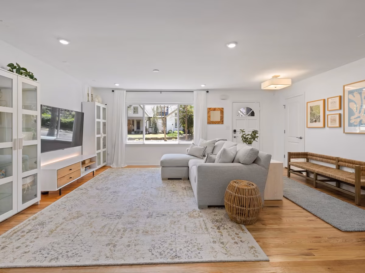 Bright living room with clean floors and neatly arranged furniture